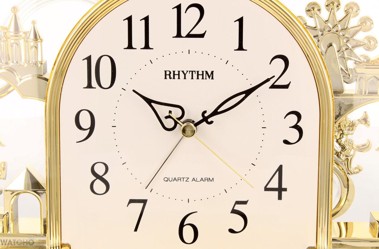 Rhythm Alarm Mantel Clock with rotating Pendulum Gilt