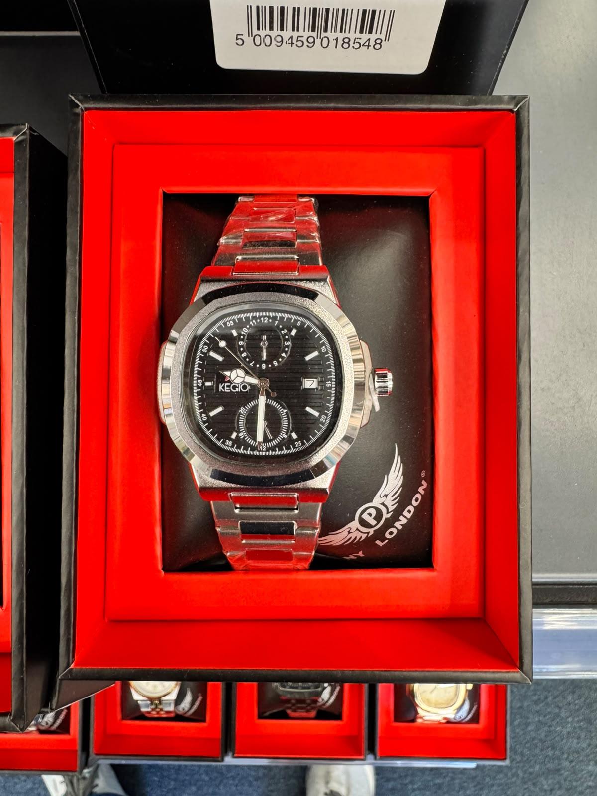A stainless steel wristwatch with a black dial and matching steel link bracelet, presented inside a red-lined watch box. The dial has 'PANDORA LONDON' branding.