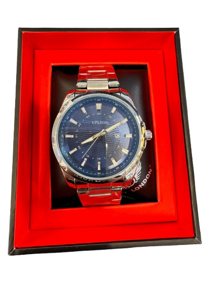 A Tudor watch with a blue sunburst dial and silver-tone case and bracelet, presented inside an open red-lined gift box.